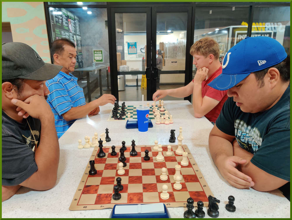 May 31st, 2022. Ka Makana Alii chess meetup. Jeremy vs Ceazar (near board). Eddie takes on young boy (far board).