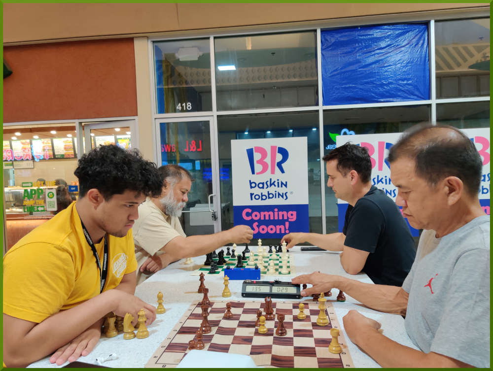 June 7th, 2022. Ka Makana Alii chess meetup. Christian vs Eddie (near board). Chet vs Ryan (far board).