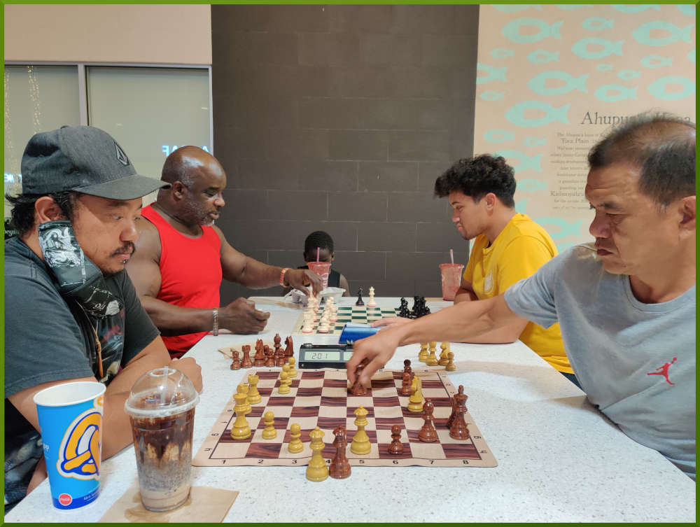 June 7th, 2022. Ka Makana Alii chess meetup. Jeremy vs Eddie (near board). Ramon vs Christian (far board).