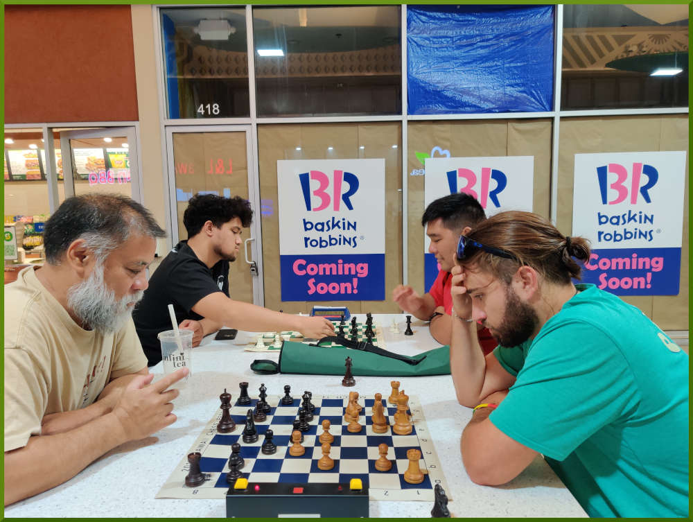 June 21st, 2022. Ka Makana Alii chess meetup. Chet vs Ari (near board). Christian vs Ceazar (far board).