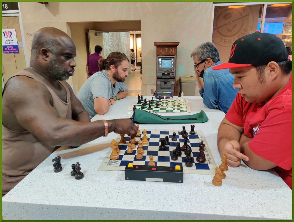 July 12th, 2022. Ka Makana Alii chess meetup. Ramon vs Ceazar (near board). Ari vs Manny (far board).