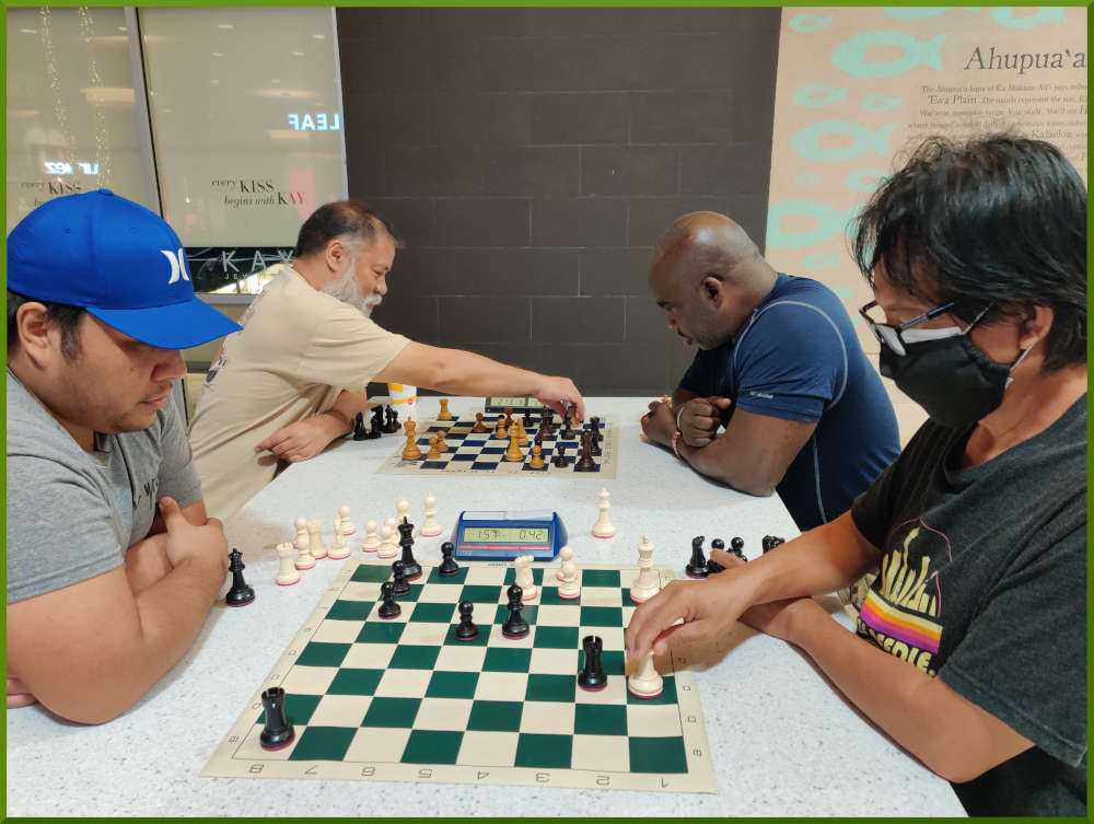 July 26th, 2022. Ka Makana Alii chess meetup. Ceazar vs Regie (near board). Chet vs Ramon (far board).
