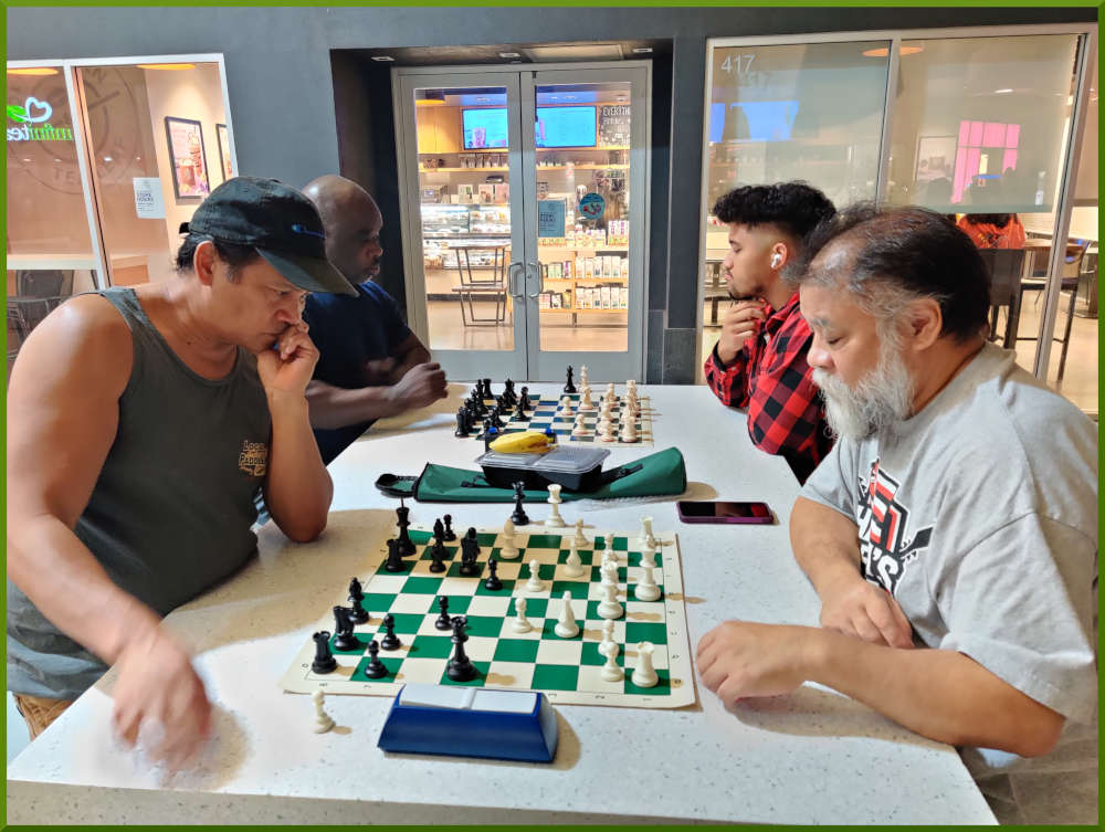 November 29th, 2022. Ka Makana Alii chess meetup. James vs Chet (near board). Ramon vs Christian (far board).