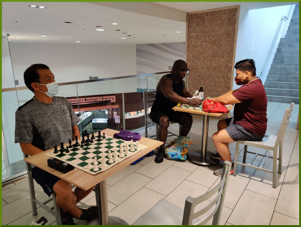 Playing chess at Pearlridge West Theatres foodcourt.