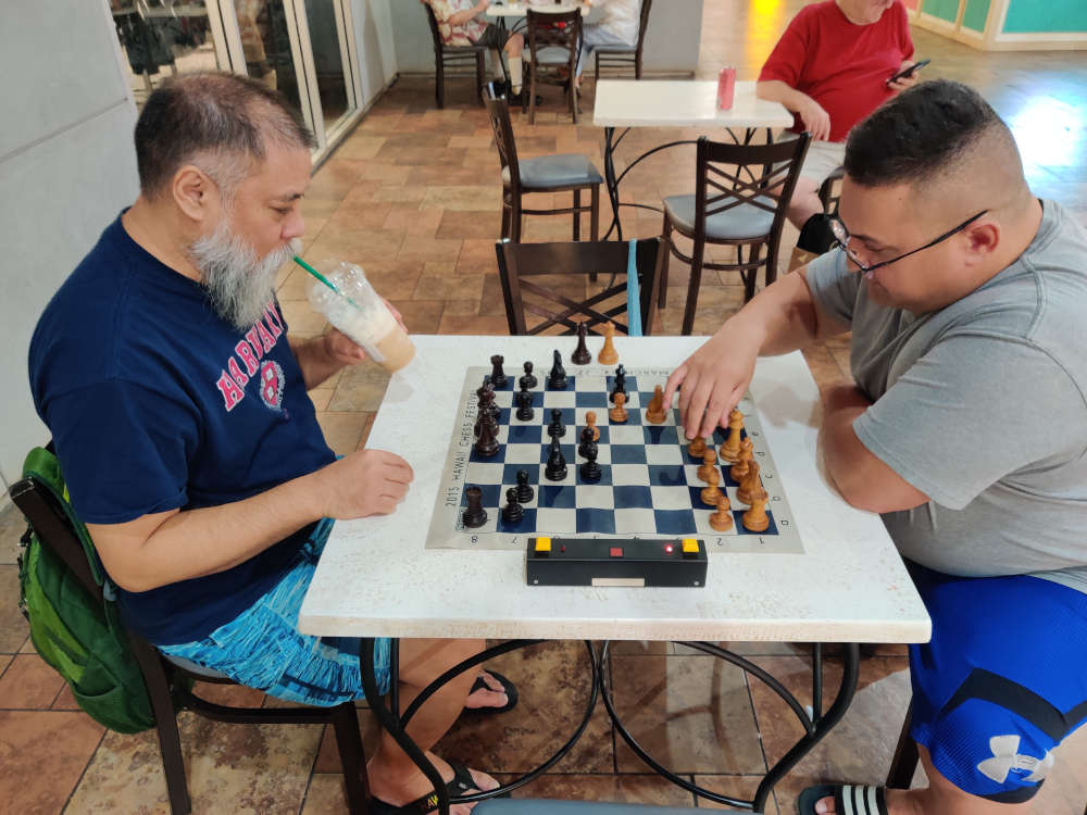 Playing chess by Macy's at Pearlridge Mall.