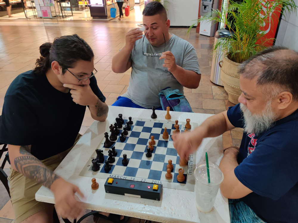 Playing chess by Macy's at Pearlridge Center.